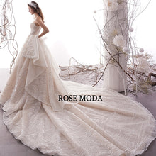 Load image into Gallery viewer, RoseModaLuxuryGlitteringWeddingDresswithLongTrainRemovableBowPrincessBallGownCustomMake-b.jpg