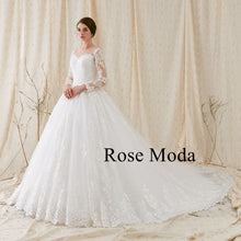 Load image into Gallery viewer, Rosemoda Nude Bateau Illusion Neckline Ball Gown Wedding Dress With Long Sleeve
